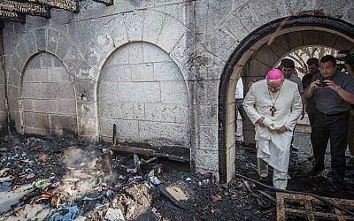A priest inspects the damage caused to the Church of the Multiplication at Tabgha, on the Sea of Galilee, in northern Israel, which was set on fire in what police suspect was an arson attack, on June 18, 2015. (Basel Awidat/Flash90) A priest inspects the damage caused to the Church of the Multiplication at Tabgha, on the Sea of Galilee, in northern Israel, which was set on fire in what police suspect was an arson attack, on June 18, 2015. (Basel Awidat/Flash90)