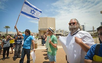 Israelis wear tape across their mouths to protest Minister of Culture Miri Regev's ostensible “silencing” of dissident voices, outside an award ceremony for Israeli theatre where Regev was present, in Tel Aviv, on June 19, 2015. Photo by FLASH90 Israelis wear tape across their mouths to protest Minister of Culture Miri Regev's ostensible “silencing” of dissident voices, outside an award ceremony for Israeli theatre where Regev was present, in Tel Aviv, on June 19, 2015. Photo by FLASH90