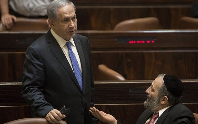Prime Minister Benjamin Netanyahu speaks with then-economy minister Aryeh Deri in the Knesset, June 29, 2015. (Hadas Parush/Flash90) Prime Minister Benjamin Netanyahu speaks with then-economy minister Aryeh Deri in the Knesset, June 29, 2015. (Hadas Parush/Flash90)