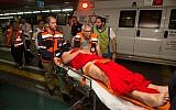 An Israeli wounded in a drive-by shooting attack is brought to Shaare Zedek hospital in Jerusalem, June 29, 2015. (Yonatan Sindel/Flash90)