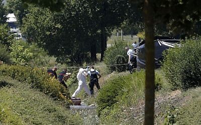 Investigating police officers work outside the plant where a terrorist attack took place, Friday, June 26, 2015 in Saint-Quentin-Fallavier, southeast of Lyon, France. (AP Photo/Laurent Cipriani)