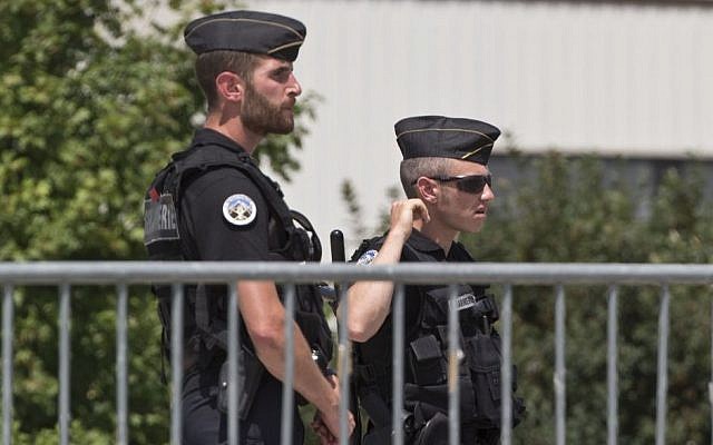 Police officers guard a road leading to a plant which was attacked on Friday in Saint-Quentin-Fallavier, southeast of Lyon, France, Saturday, June 27, 2015. (AP/Michel Euler) Police officers guard a road leading to a plant which was attacked on Friday in Saint-Quentin-Fallavier, southeast of Lyon, France, Saturday, June 27, 2015. (AP/Michel Euler)