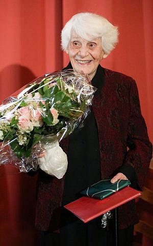 Ingeborg Syllm-Rapoport holds her doctoral certificate and a bunch of flowers during a ceremony at the University Clinic Hamburg-Eppendorf in Hamburg, Germany, Tuesday, June 9, 2015. (Bodo Marks/dpa via AP)