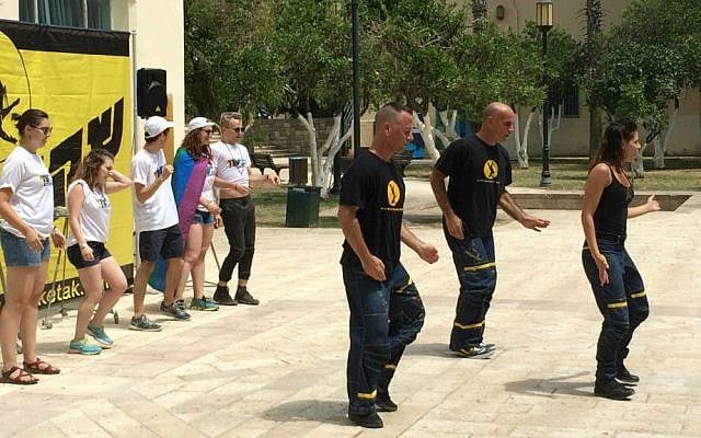 Birthright Israel participants (left) dance with members of the Sheketak troupe at the Suzanne Dellal Center in Jaffa, June 9, 2015. (Renee Ghert-Zand/Time of Israel)