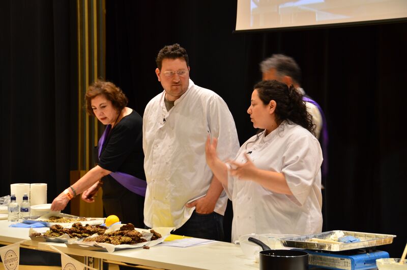 Husband-and-wife couple Itamar Srulovich (center) and Sarit Packer (right) demonstrate a cooking technique at London's Gefiltefest on June 28, 2015. The couple runs a wildly successful bistro in the city center, Honey & Co. (courtesy) Husband-and-wife couple Itamar Srulovich (center) and Sarit Packer (right) demonstrate a cooking technique at London's Gefiltefest on June 28, 2015. The couple runs a wildly successful bistro in the city center, Honey & Co. (courtesy)