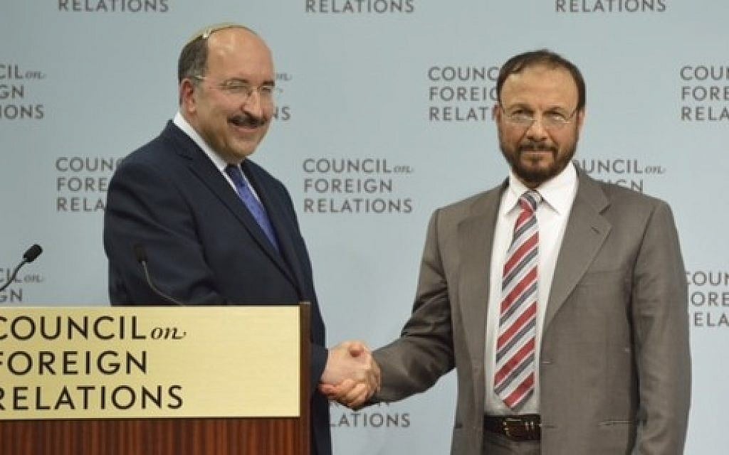 Dore Gold and former Saudi government adviser Anwar Eshki shake hands in Washington DC, June 4, 2015. (Debby Communications Group)