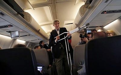 Secretary of State John Kerry plays with his crutches as he talks to reporters before leaving from Andrews Air Force Base, Md., Friday, June 26, 2015, en route to Vienna, Austria. (Carlos Barria/Pool Photo via AP)
