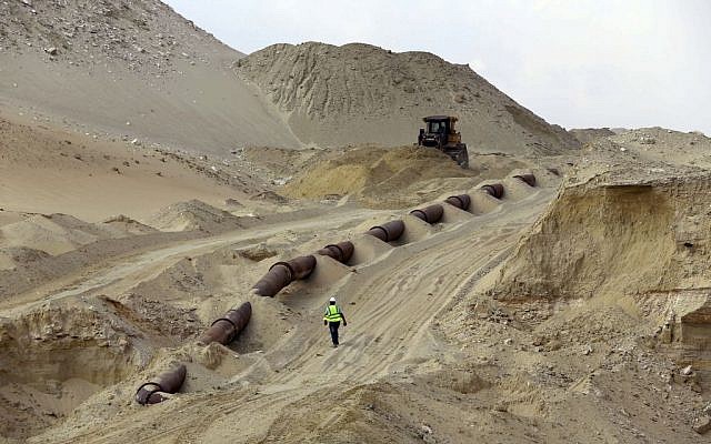 Bulldozers work on a new section of the Suez canal during a media tour in Ismailia, Egypt, Saturday, June 13, 2015.  (AP Photo/Hassan Ammar)