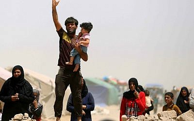 In this Friday, May 22, 2015 file photo, displaced civilians from Ramadi and central Iraq live in a camp in the town of Amiriyat al-Fallujah, west of Ramadi, 65 kilometers (40 miles) west of Baghdad. (AP Photo/Hadi Mizban)
