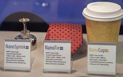 A sprinkler, tie and coffee cup with hidden cameras are featured at an expo of Israeli intelligence-gathering technology in Tel Aviv, Israel, Tuesday, June 30, 2015. (AP Photo/Dan Balilty)