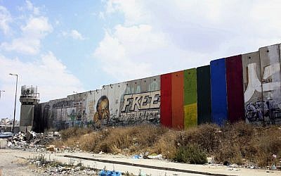 This Monday, June 29, 2015 photo provided by Palestinian artist Khaled Jarrar shows his painting of a rainbow flag on six slabs of the West Bank security barrier in the West Bank city of Ramallah. (Khaled Jarrar via AP)