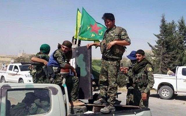 Kurdish fighters of the YPG sit on their pickup truck in the town of Ein Eissa, north of Raqqa city, Syria, Tuesday, June 23, 2015. (The Kurdish fighters of the People's Protection Units via AP) Kurdish fighters of the YPG sit on their pickup truck in the town of Ein Eissa, north of Raqqa city, Syria, Tuesday, June 23, 2015. (The Kurdish fighters of the People's Protection Units via AP)