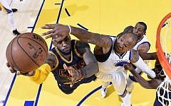 Cleveland Cavaliers forward LeBron James, left, shoots against Golden State Warriors forward Marreese Speights during the first half of Game 2 of basketball's NBA Finals in Oakland, Sunday, June 7, 2015. (Kyle Terada/USA TODAY Sports Pool/AP)
