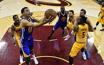 Golden State Warriors guard Stephen Curry (30) shoots in front of Cleveland Cavaliers center Tristan Thompson (13) during the second half of Game 3 of basketball's NBA Finals in Cleveland, Tuesday, June 9, 2015. The Cavaliers defeated the Warriors 96-91. (Larry W. Smith/Pool Photo via AP)