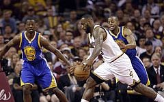Cleveland Cavaliers forward LeBron James (23) drives on Golden State Warriors forward Harrison Barnes (40) and guard Andre Iguodala (9) during the first half of Game 6 of basketball's NBA Finals in Cleveland, Tuesday, June 16, 2015. (AP/Tony Dejak)