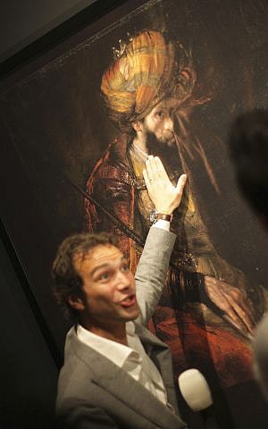 A Dutch television reporter strokes a 3D printed version of Rembrandt's "Saul and David" at a press preview of a new exhibition at the Mauritshuis museum in The Hague, Tuesday, June 9, 2015. (AP Photo/ Mike Corder)