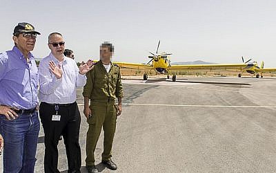 Shmuel Zucker, head of the Defense Ministry's Acquisition Administration, talks with Capricorn Medan, VP Elbit Systems aircraft and a firefighting squadron commander. (Defense Ministry/Schlomo Shoham)