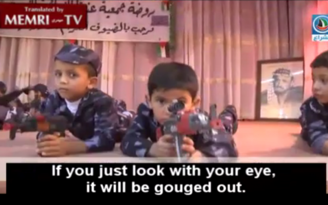 Palestinian pre-schoolers perform with toy guns at a West Bank kindergarten, June 2015. A photograph of Yasser Arafat is at the back of the stage. (MEMRI screenshot)
