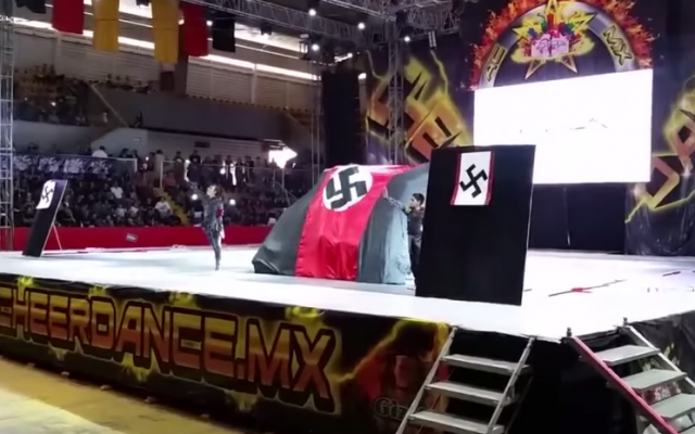 A Mexican cheer-dance team performs a routine in which they displayed flags with swastikas, as reported on Friday, June 12, 2015 (YouTube screen cap) A Mexican cheer-dance team performs a routine in which they displayed flags with swastikas, as reported on Friday, June 12, 2015 (YouTube screen cap)