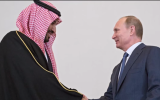 Russia's President Vladimir Putin (r) shakes hands with Saudi Arabia's Ambassador to Russia Abdulrahman Al-Rassi after signing a nuclear power cooperation deal on June 18, 2015. (Screen shot: YouTube)