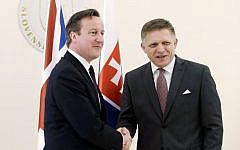 Slovakia's Prime Minister Robert Fico, right, welcomes British Prime Minister David Cameron, left, in Bratislava, Slovakia, Friday, June 19, 2015. (AP/Petr David Josek)