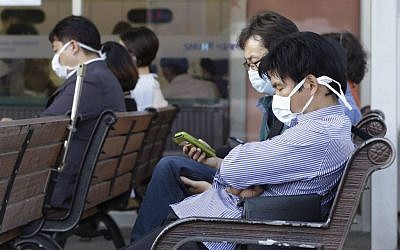 South Koreans wearing masks as a precaution against the Middle East Respiratory Syndrome virus sit at an emergency room at Seoul National University Hospital in Seoul, South Korea Monday, June 1, 2015. (AP/Ahn Young-joon)