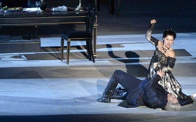 Moment of passion: Tosca kills Scarpio, who has imprisoned and tortured her lover, with a table knife. (courtesy Israel Opera/Yossi Zwecker)