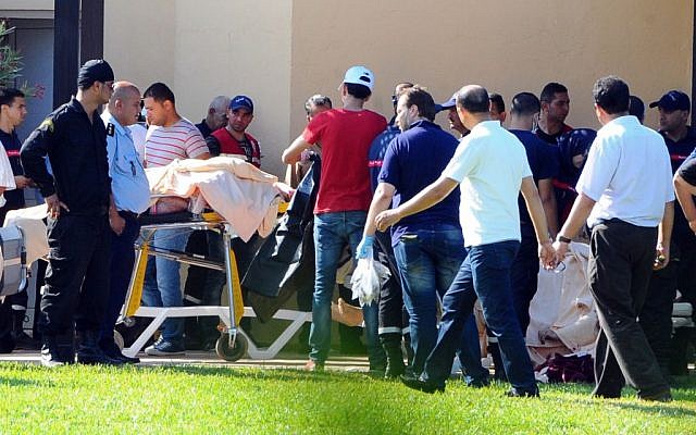 Injured people are treated near the area where a terror attack took place in Sousse, Tunisia, Friday June 26, 2015. (AP Photo/Hassene Dridi) Injured people are treated near the area where a terror attack took place in Sousse, Tunisia, Friday June 26, 2015. (AP Photo/Hassene Dridi)