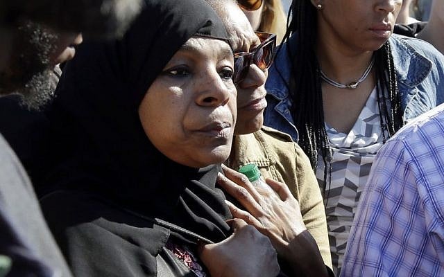 Rahimah Rahim, left, mother of shooting victim Usaama Rahim, listens during a news conference Thursday, June 4, 2015, in Boston's Roslindale neighborhood in the area where Rahim was shot to death.  (AP Photo/Elise Amendola)