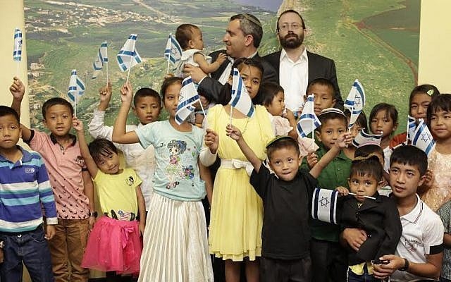 Rabbi Michael Freund (right) stands next to Absorption Minister Ze'ev Elkin (center), while the latter holds one of several young immigrants who arrived on a group flight, June 18, 2015. (Courtesy Ze'ev Elkin's office) Rabbi Michael Freund (right) stands next to Absorption Minister Ze'ev Elkin (center), while the latter holds one of several young immigrants who arrived on a group flight, June 18, 2015. (Courtesy Ze'ev Elkin's office)