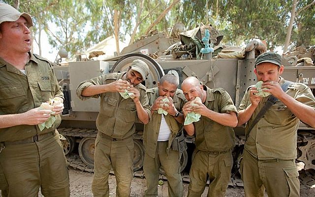 Illustrative photo: IDF reserve soldiers seen eating in a staging area near the border with Gaza in Southern Israel on July 20, 2014, during Israel's Operation Protective Edge. (Moshe Shai/Flash90) Illustrative photo: IDF reserve soldiers seen eating in a staging area near the border with Gaza in Southern Israel on July 20, 2014, during Israel's Operation Protective Edge. (Moshe Shai/Flash90)