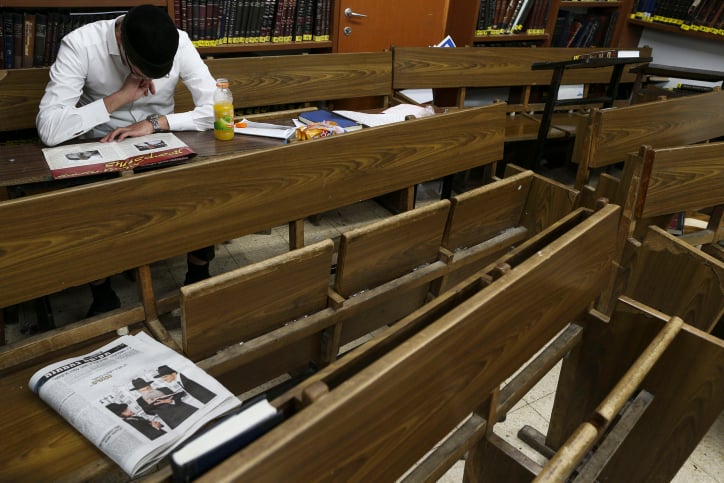 A young ultra-Orthodox Jewish man seen reading a newspaper in between studies at the Yeshiva Ateret Israel, in Jerusalem. September 02, 2013. (Nati Shohat/FLASH90) A young ultra-Orthodox Jewish man seen reading a newspaper in between studies at the Yeshiva Ateret Israel, in Jerusalem. September 02, 2013. (Nati Shohat/FLASH90)
