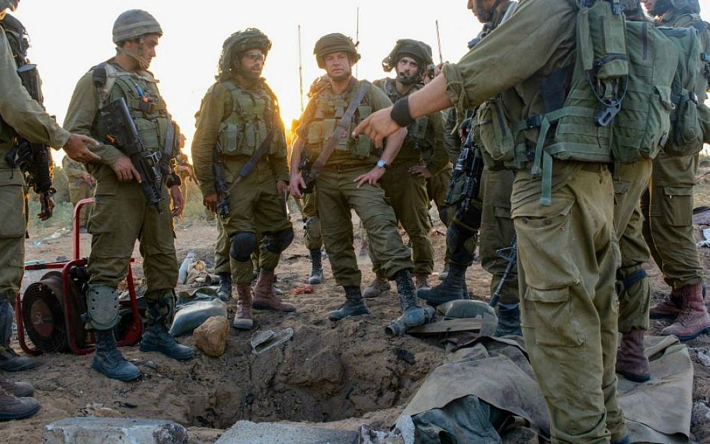 IDF infantrymen congregating around a tunnel entrance in Gaza, July 24, 2014. (Courtesy IDF Flickr)