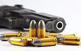 Illustrative image of a gun and bullets. (A gun and bullets via Shutterstock)