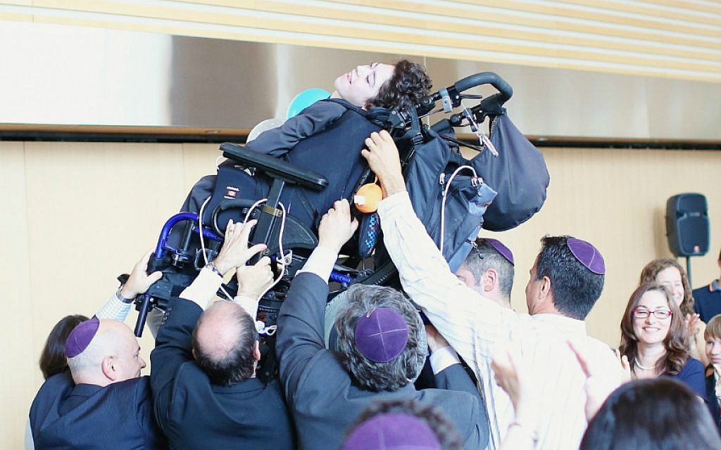 Friends and family lift Jacob Trossman as they dance at his bar mitzvah celebration in Toronto on May 18, 2015. (Nechama Laitman Photography) Friends and family lift Jacob Trossman as they dance at his bar mitzvah celebration in Toronto on May 18, 2015. (Nechama Laitman Photography)
