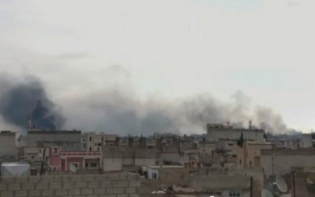 Smoke rises over the northern Syrian city of Kobani, on the Turkish border, during battles against Islamic State. (Screen capture: YouTube) Smoke rises over the northern Syrian city of Kobani, on the Turkish border, during battles against Islamic State. (Screen capture: YouTube)