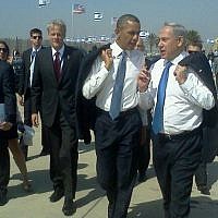 Prime Minister Benjamin Netanyahu and President Barack Obama talk at Ben Gurion Airport after Obama's arrival in Israel in March 2013. Michael Oren walks behind Obama (Via Facebook)