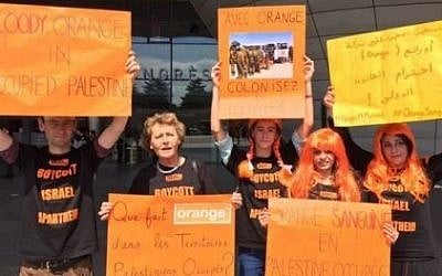 A photo by BDS France showing protesters calling on the cellular provider to cut ties with Israel. The signs say in French 'Blood red Orange in occupied Palestine,' 'What is Orange doing in the occupied Palestinian territories?' and 'Colonized and limited with Orange.' (Screen capture: Electronic Intifada) A photo by BDS France showing protesters calling on the cellular provider to cut ties with Israel. The signs say in French 'Blood red Orange in occupied Palestine,' 'What is Orange doing in the occupied Palestinian territories?' and 'Colonized and limited with Orange.' (Screen capture: Electronic Intifada)