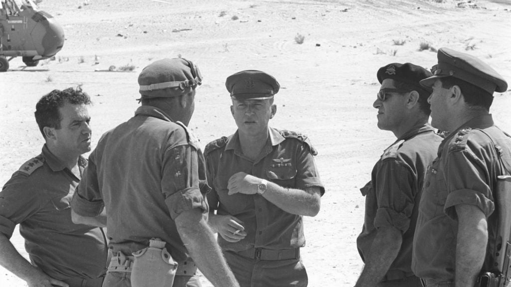 Yitzhak Rabin, center with cap, as Chief of IDF General Staff, during the Six Day War, speaking with the commander of the southern front Yeshayahu Gavish, opposite (Courtesy of Israel Defense Force Archive) Yitzhak Rabin, center with cap, as Chief of IDF General Staff, during the Six Day War, speaking with the commander of the southern front Yeshayahu Gavish, opposite (Courtesy of Israel Defense Force Archive)