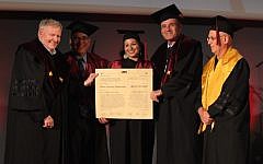 Haifa University President Amos Shapira (left) presents honorary Ph.D degrees to Shira and Jay Ruderman (center, second right) (Gil Hadani)