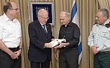 Israel Shrir, 79 (2-R), receives a citation for excellence from Defense Minister Moshe Ya'alon (L), President Rivlin (2-L) and Chief of Staff Gadi Eisenkot (R), Monday June 8, 2015. (Mark Neyman/GPO)