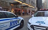 Police parked outside the Waldorf Astoria Hotel after a wedding guest accidentally sets off a gun, injuring a guest, June 13, 2015. (YouTube screenshot)