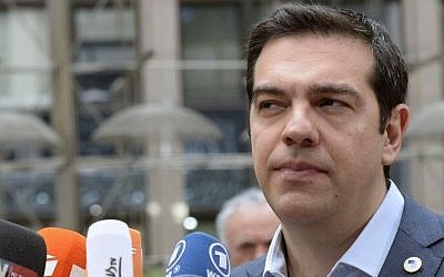 Greek Prime Minister Alexis Tsipras talks to the media as he arrives for a meeting of the leaders of the 19 countries that use the euro, in Brussels on July 12, 2015. (AFP / THIERRY CHARLIER)