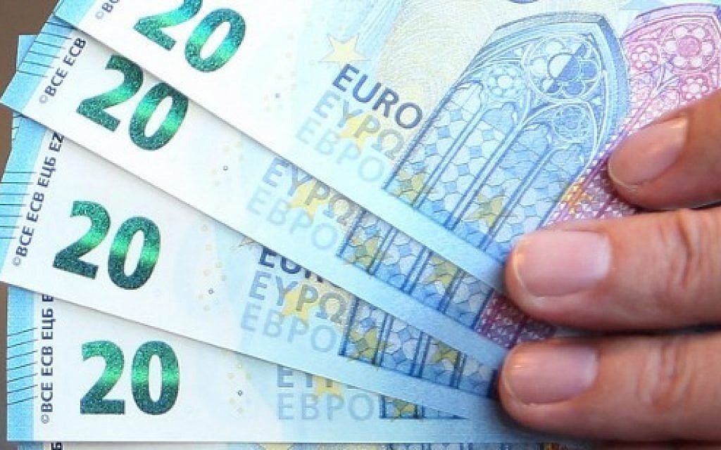 Illustrative: A man holding some new 20 Euro notes in Frankfurt am Main, western Germany. (Daniel Roland/AFP)