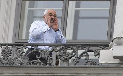 Iranian Foreign Minister Mohammad Javad Zarif shouts from a balcony of the Palais Coburg Hotel where the Iran nuclear talks meetings were held in Vienna, Austria, on July 13, 2015. (AFP/JOE KLAMAR)