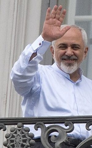 Iranian Foreign Minister Mohammad Javad Zarif waves from a balcony of the Palais Coburg Hotel where the Iran nuclear talks meetings are being held in Vienna, Austria on July 13, 2015. (Joe Klamar/AFP)