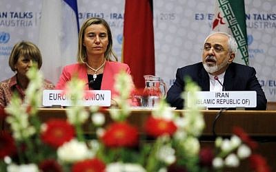 Iranian Foreign Minister Mohammad Javad Zarif (R) speaks next to European Union High Representative for Foreign Affairs and Security Policy Federica Mogherini (C) during a plenary session at the United Nations building in Vienna, Austria July 14, 2015. (Carlos Barria/AFP)