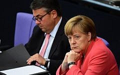 German Chancellor Angela Merkel (right) and Economy Minister Sigmar Gabriel (left) listen to a debate in the Bundestag, the German lower house of parliament in Berlin, on July 17, 2015. (John McDougall/AFP)