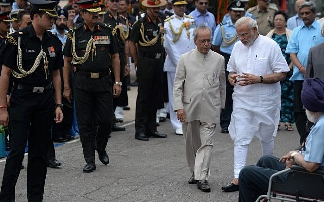 Indian Prime Minister Narendra Modi, right, and President Pranab Mukherjee seen surrounded by members of staff in New Delhi, July 28, 2015. (AFP/PRAKASH SINGH) Indian Prime Minister Narendra Modi, right, and President Pranab Mukherjee seen surrounded by members of staff in New Delhi, July 28, 2015. (AFP/PRAKASH SINGH)