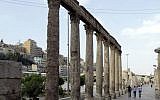 Tourists visiting part of the ancient Roman amphitheater in the Jordanian capital, Amman on  June 30, 2015. (AFP PHOTO / KHALIL MAZRAAWI)